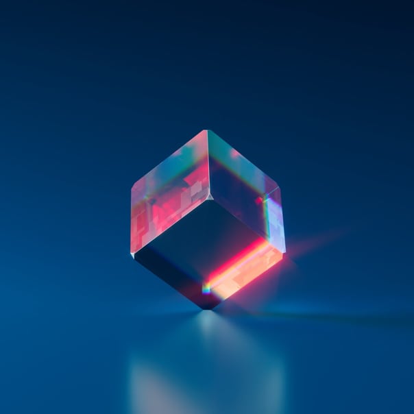 A blue cube resting on a vertex with red light shining through, and a reflection under